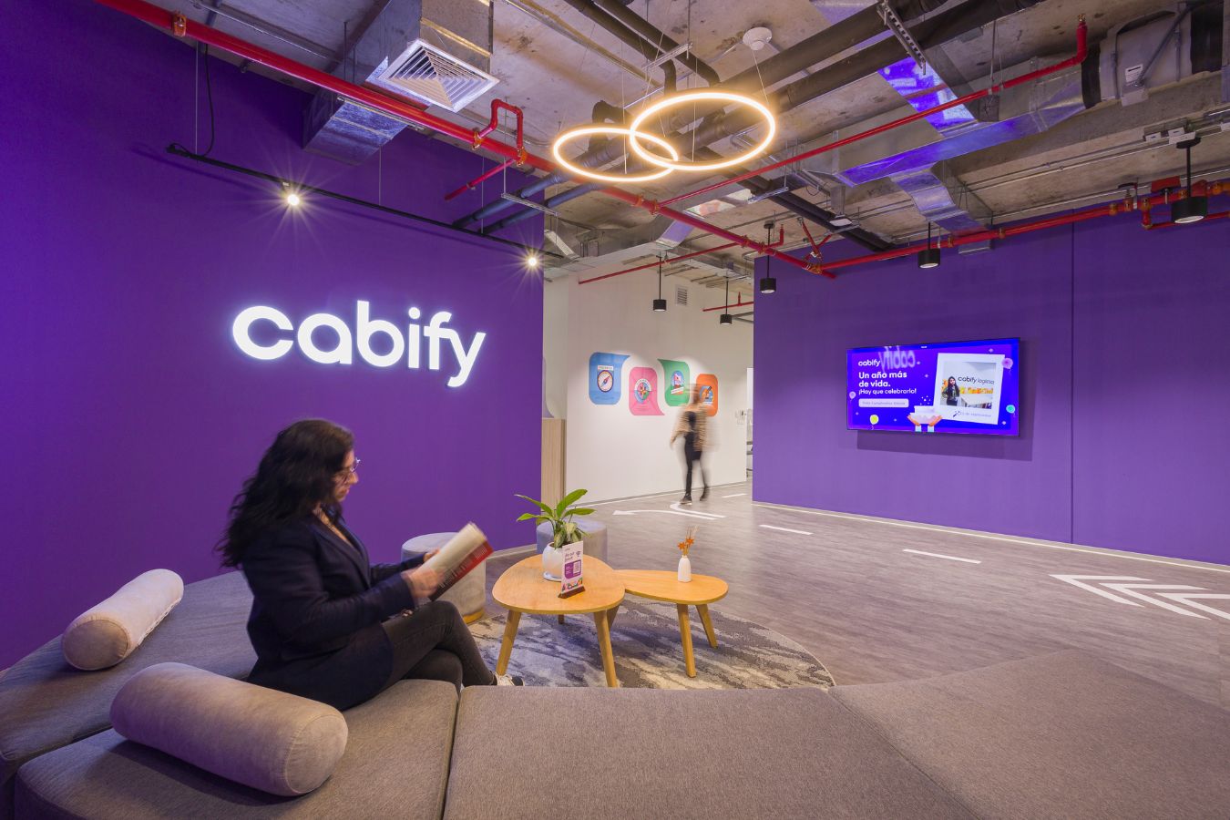 Cabify Offices - Relaxed reception lounge with signature purple wall and neon signage - Contract Workplaces.jpg